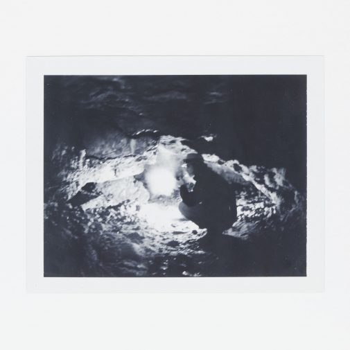 Exploring cave with gas lantern. Shot on Polaroid Land Camera with Fuji FP-3000B.