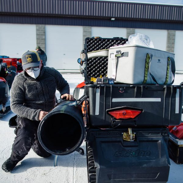 Phillip Towsend, of the Iditarod Insiders trail team, prepares his snow machine for the coming trip.