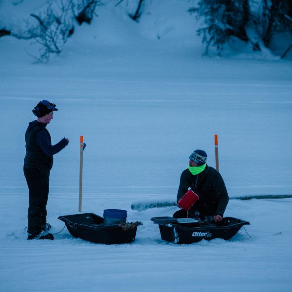 Travis Beals and Joar Leifseth Ulsom chat at the watering hole. This year the mushers are responsible for getting their dogs water from the river at the Nikolai checkpoint.