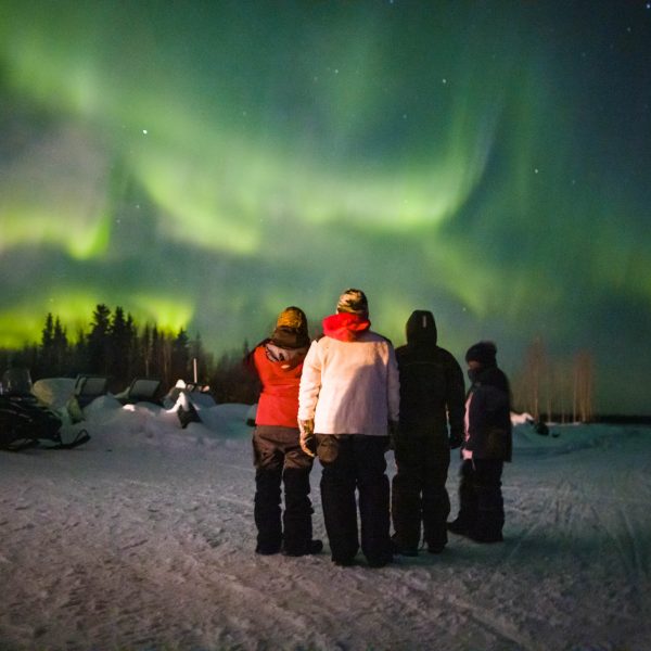 Local Nikolai family watch the northern lights while they wait for Dallas Seavey to arrive.
