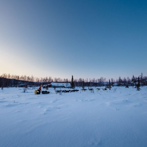 Brent Sass mushing past the Iditarod ghost town.